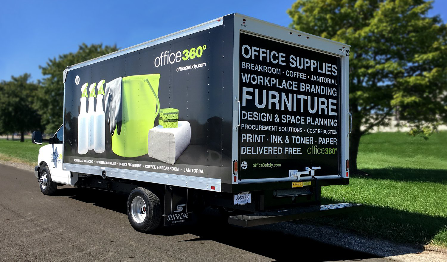 Bright commercial van with custom sign wrap showcasing office branding and cleaning products.