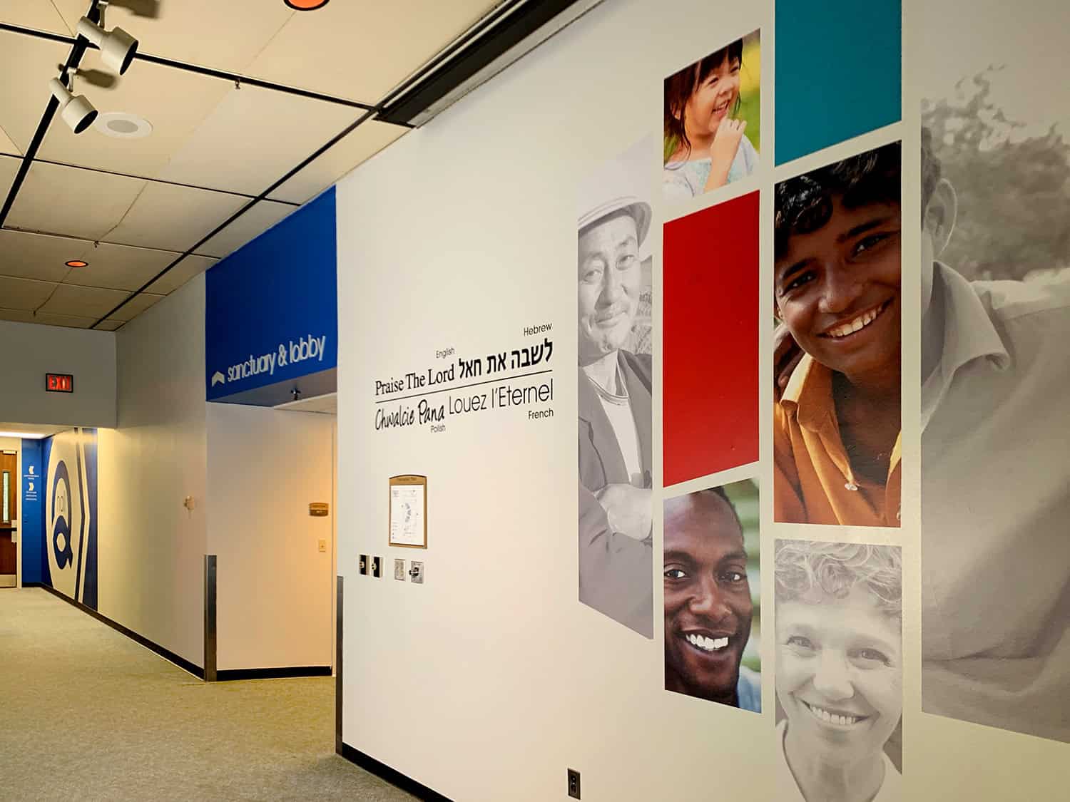 Vibrant multicultural photo wall in health care facility with customised signage and wall art.