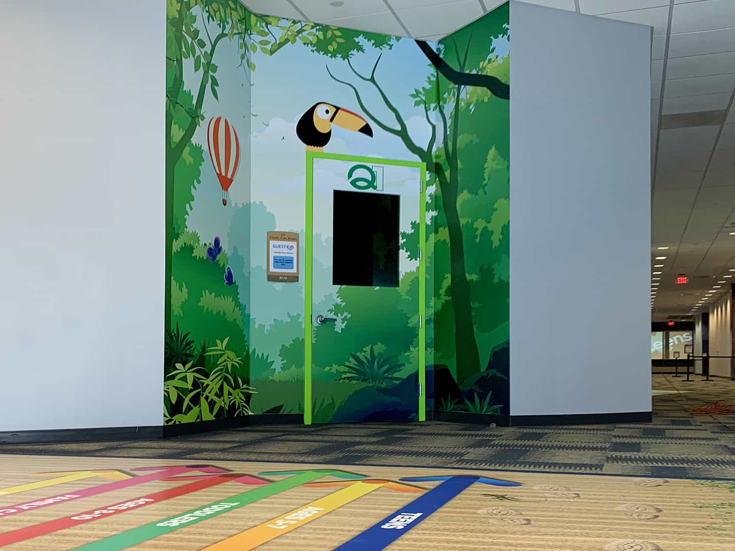Vibrant jungle-themed kids' play area sign with colourful wildlife mural and digital booking system, signage for children’s amusement and entertainment, Signworks.