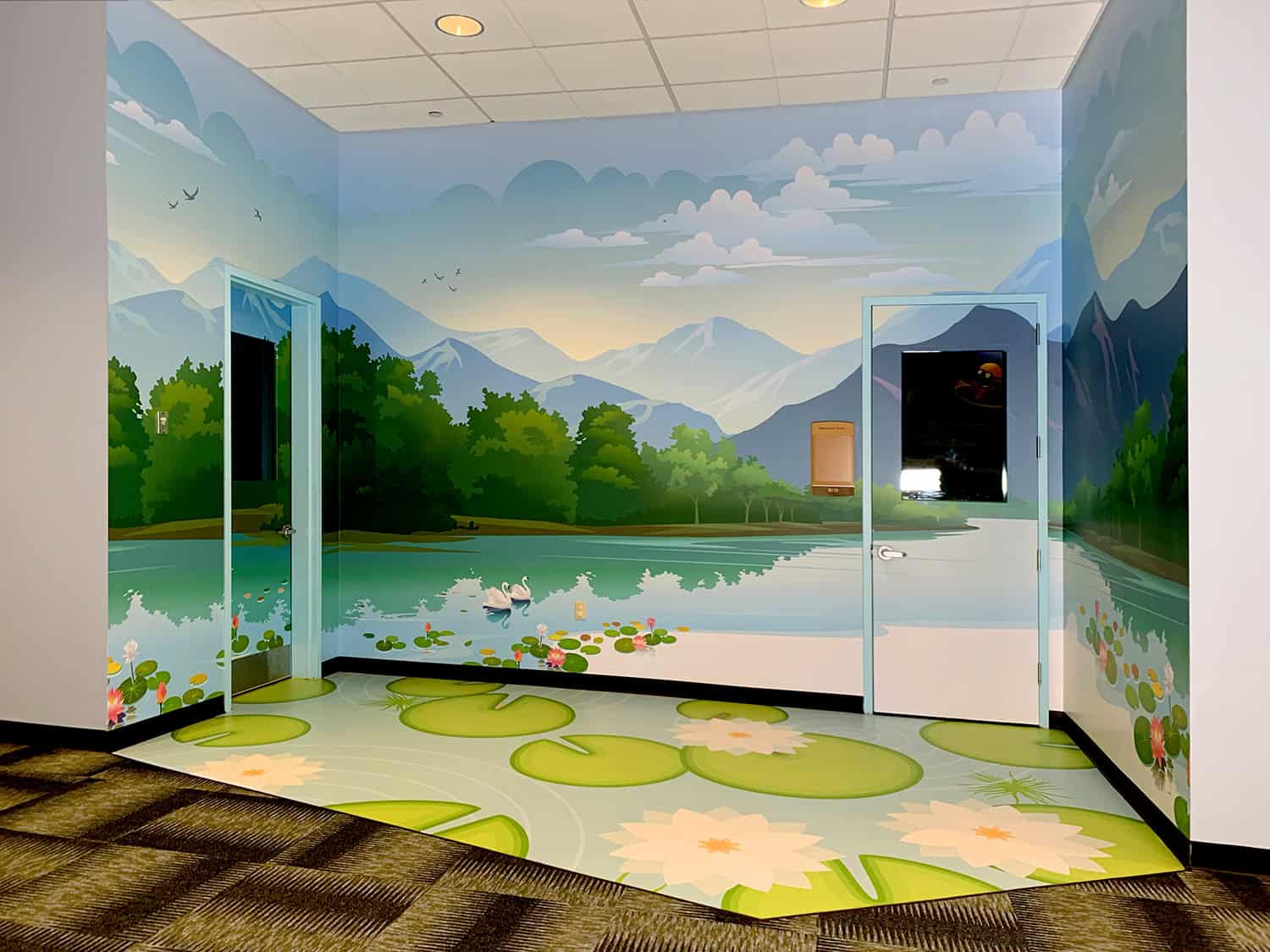 Colourful children's playroom with mountain mural wall artwork and educational toys.