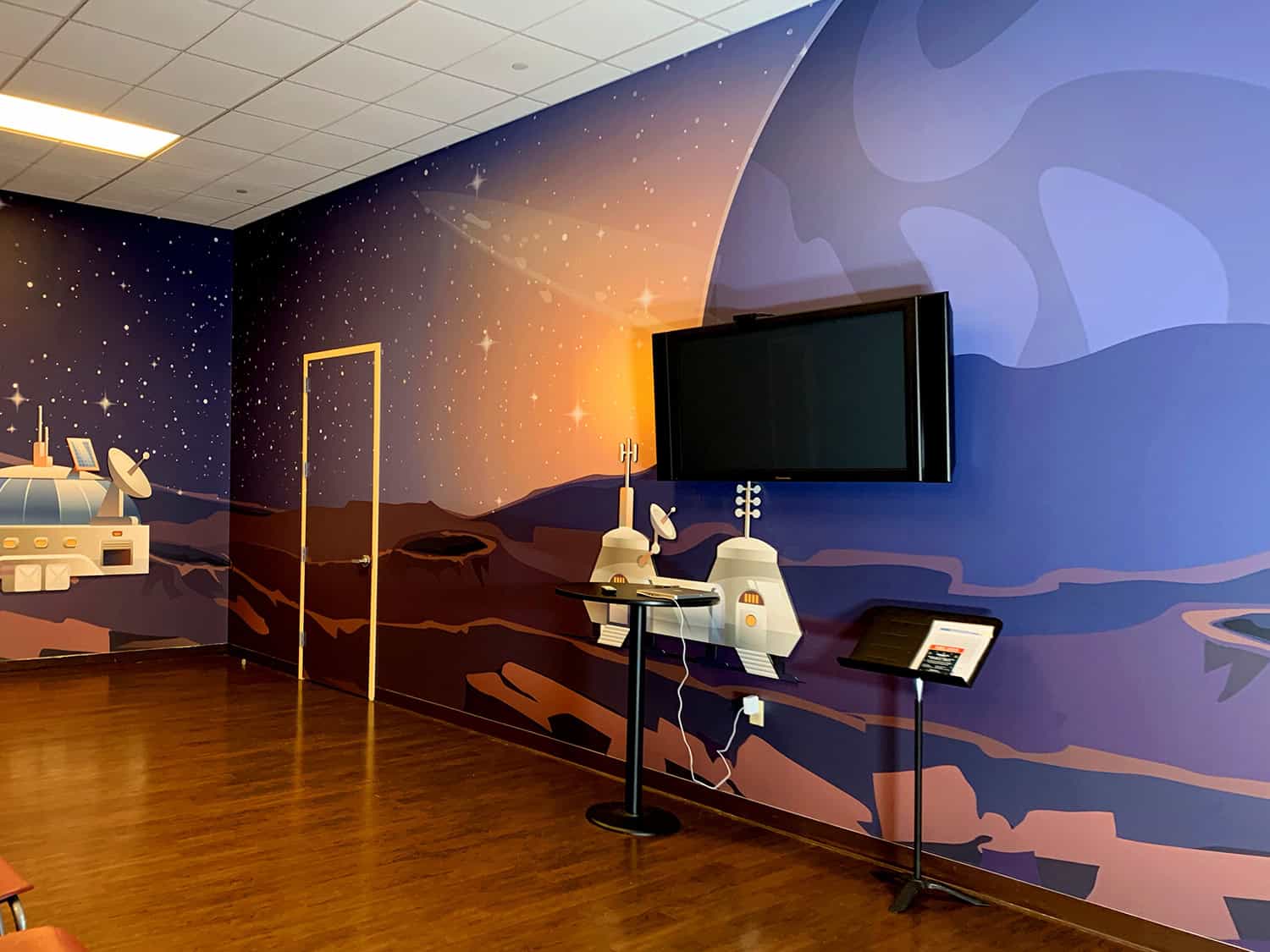 Futuristic space-themed wall mural with planets, stars, and sci-fi elements for creative interior design.