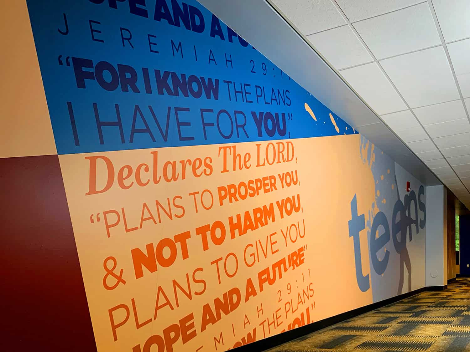 Bible verse wall mural at church, inspirational religious artwork, faith-based decor.