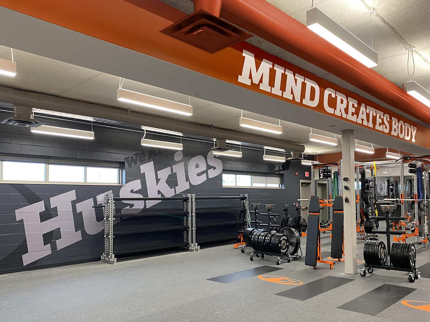 Bright gym interior with motivational signage and state-of-the-art workout equipment.