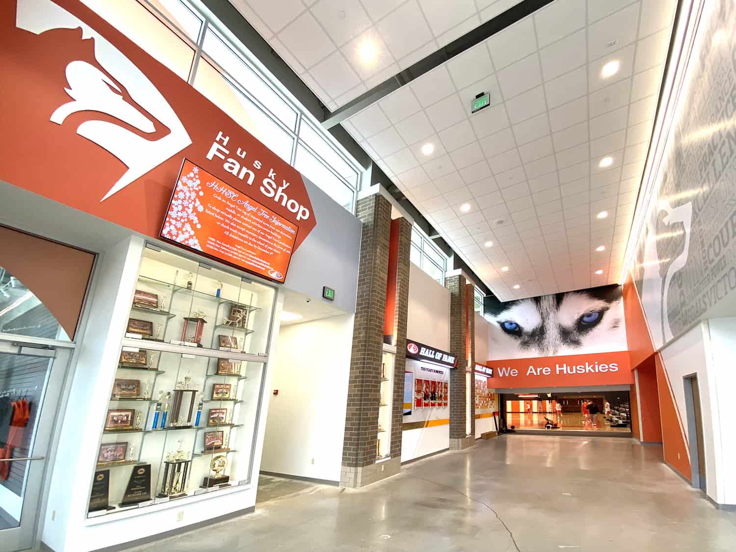 Vibrant interior of the Husky Fan Shop with branded signage and Husky artwork.