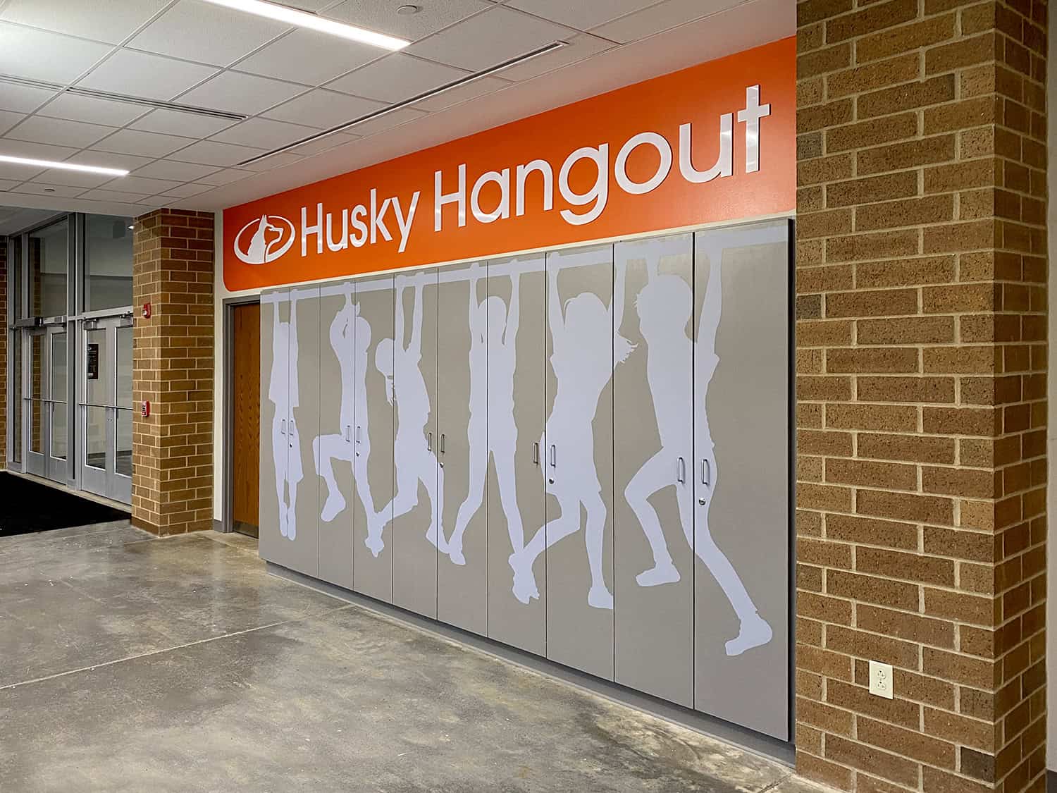 Colourful storefront signage for Huskies, with stylish silhouettes and bold branding.