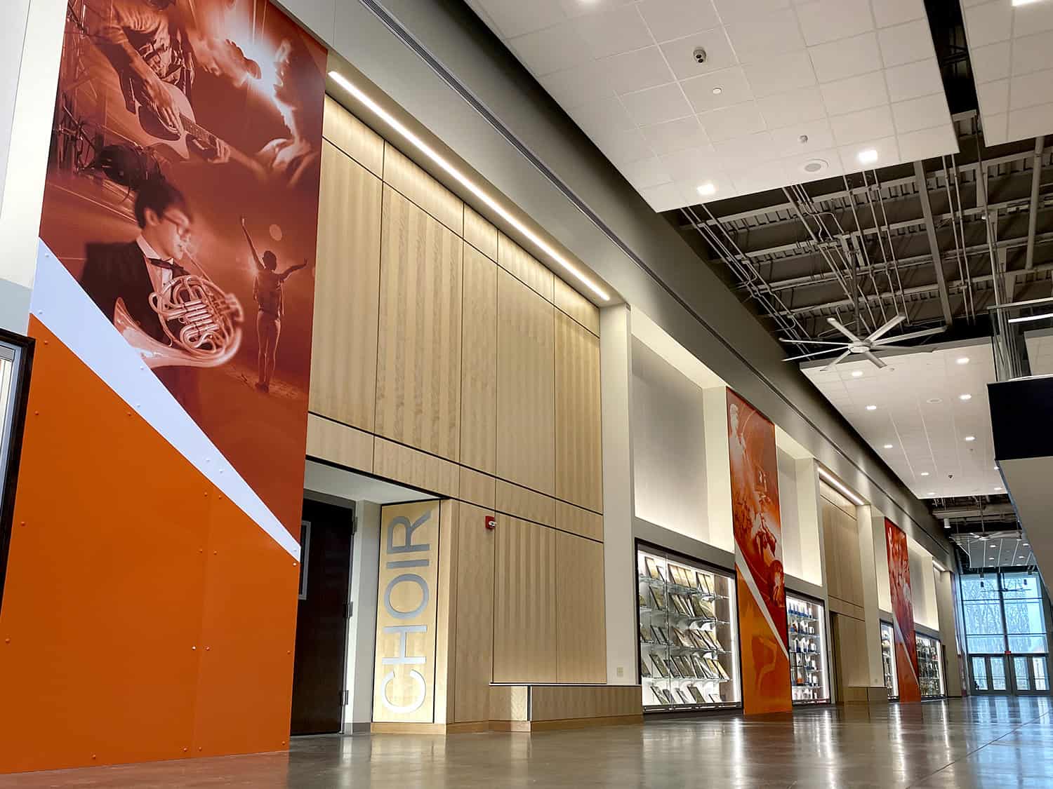 Bright orange and red indoor advertising banners showcasing custom signage and branding solutions.