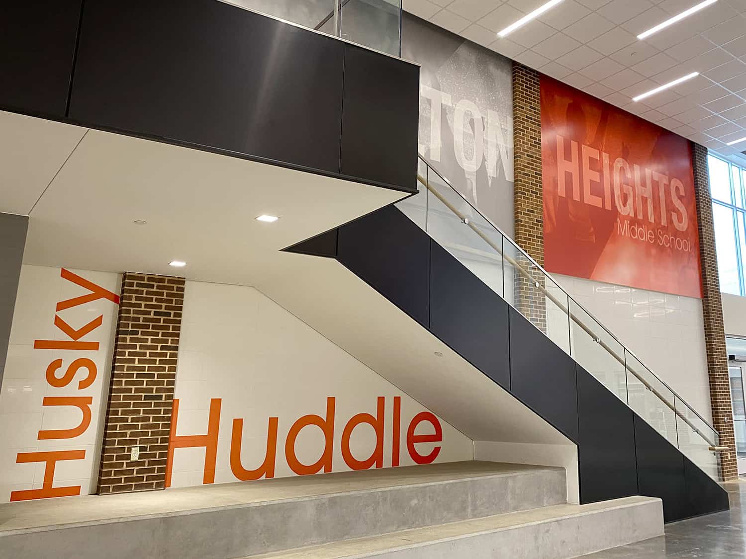 Vibrant school interior with large signage for Huddles Middle School.