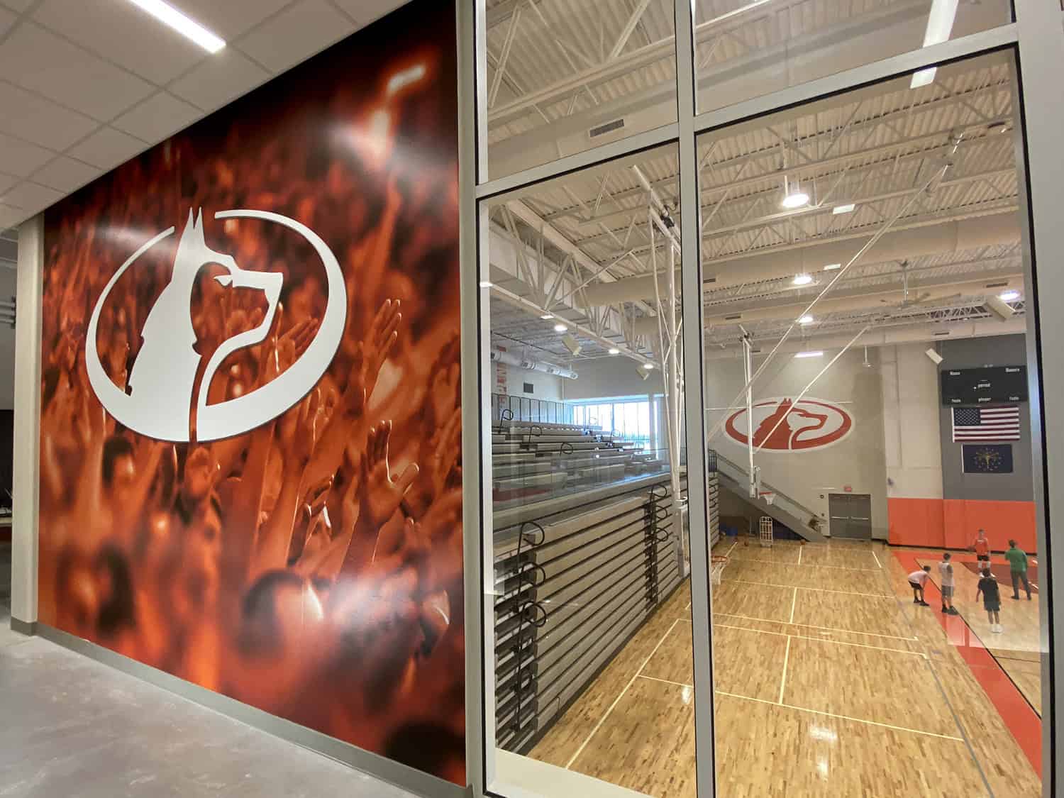 Bold, vibrant sports gym wall sign with team logo showcasing professional sign making.