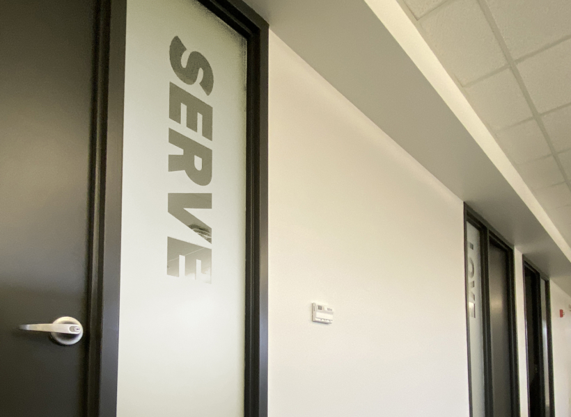 Custom office glass door sign with etched lettering for professional signage solutions.