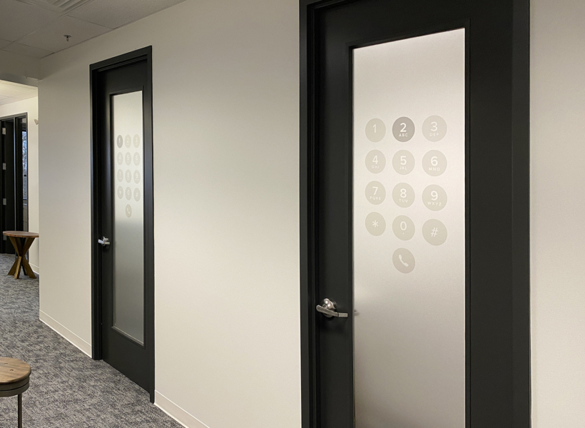 Modern office doors with custom digital keypad signage.