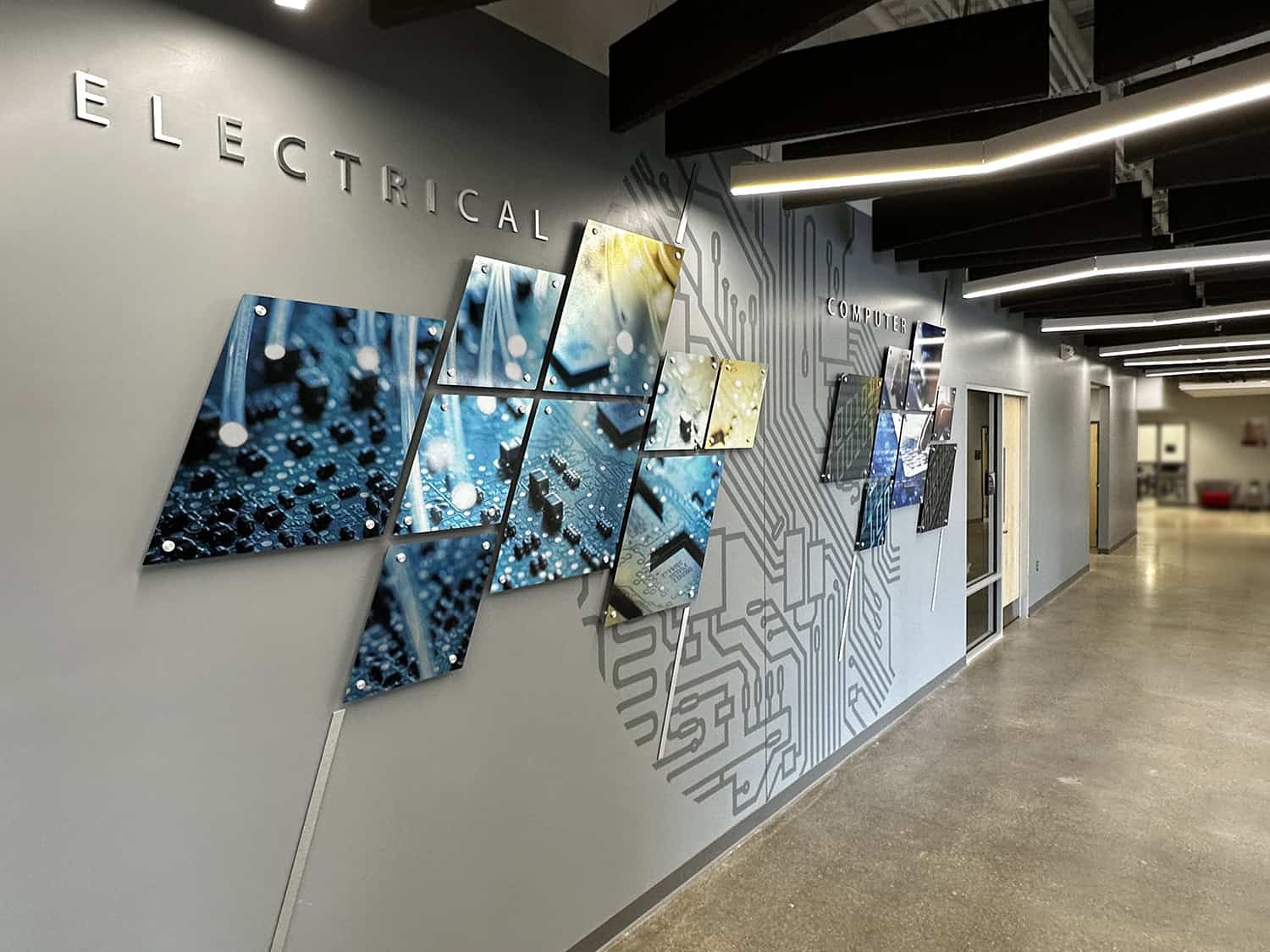 Circuit board wall art with illuminated signage and digital tech theme.