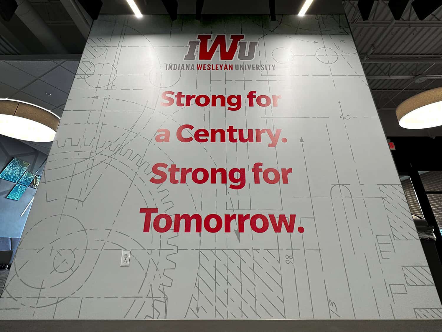 Innovative university branding sign with bold red text for Indiana Wesleyan University.