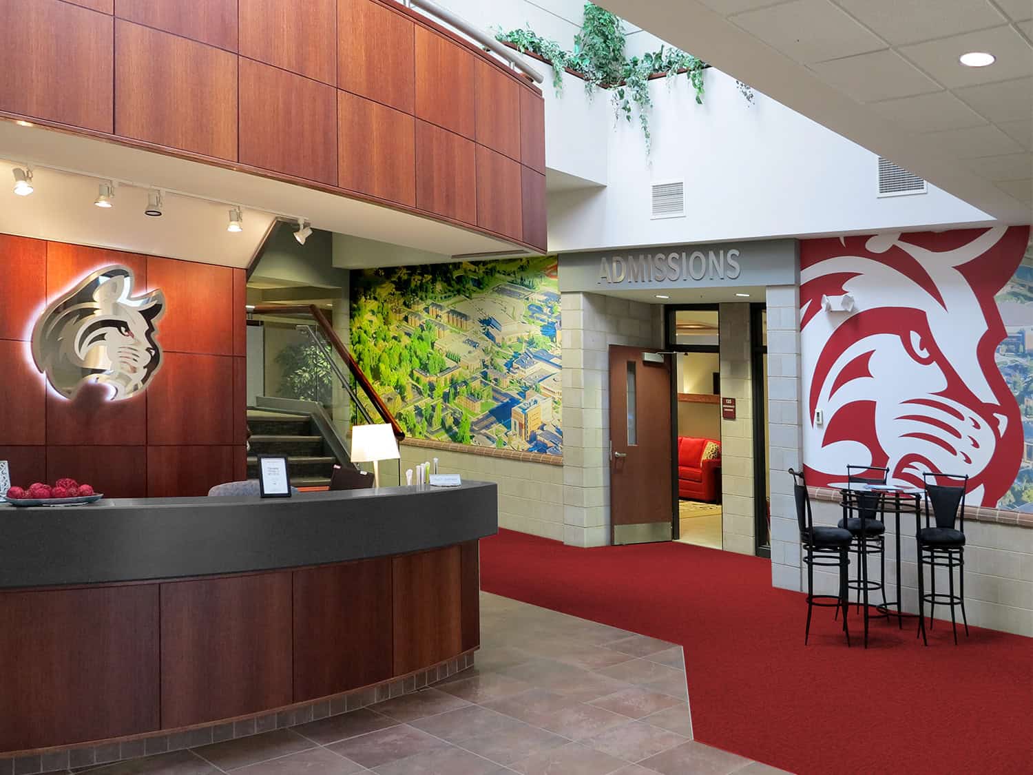 Modern university admissions office with custom signage and vibrant artwork.