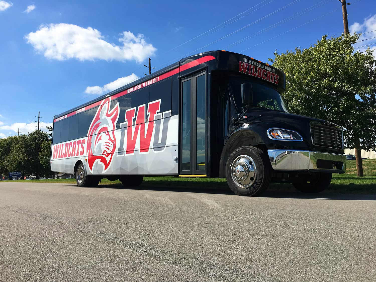 Custom university sports team promotional vehicle with Wildcats branding for Indiana Wesleyan University.