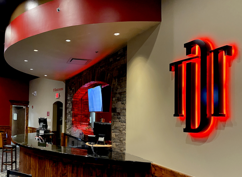 Custom 3D illuminated sign with red backlight for professional branding.