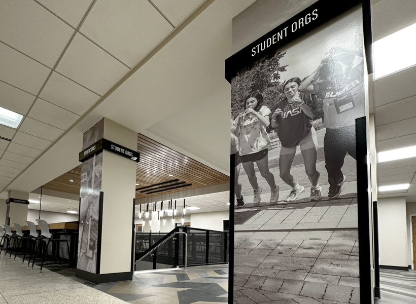 Stylish large black and white student-focused poster visuals at indoor campus or educational centre.