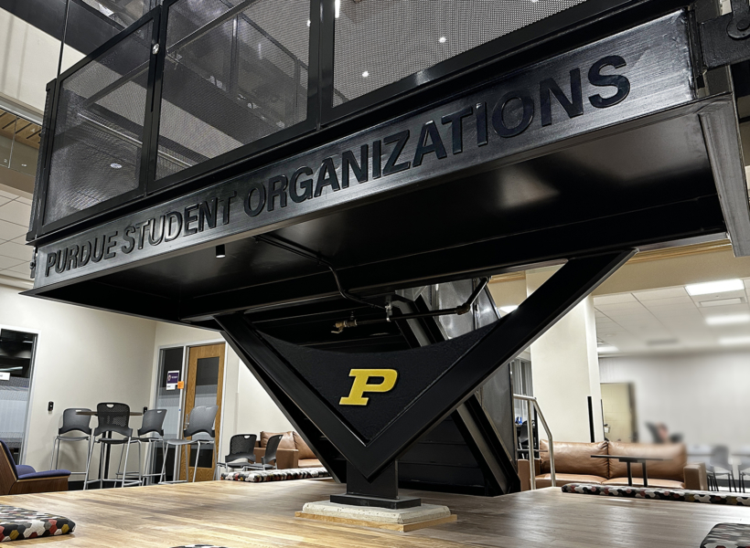 Purdue Student Organization sign on a modern staircase in university building.