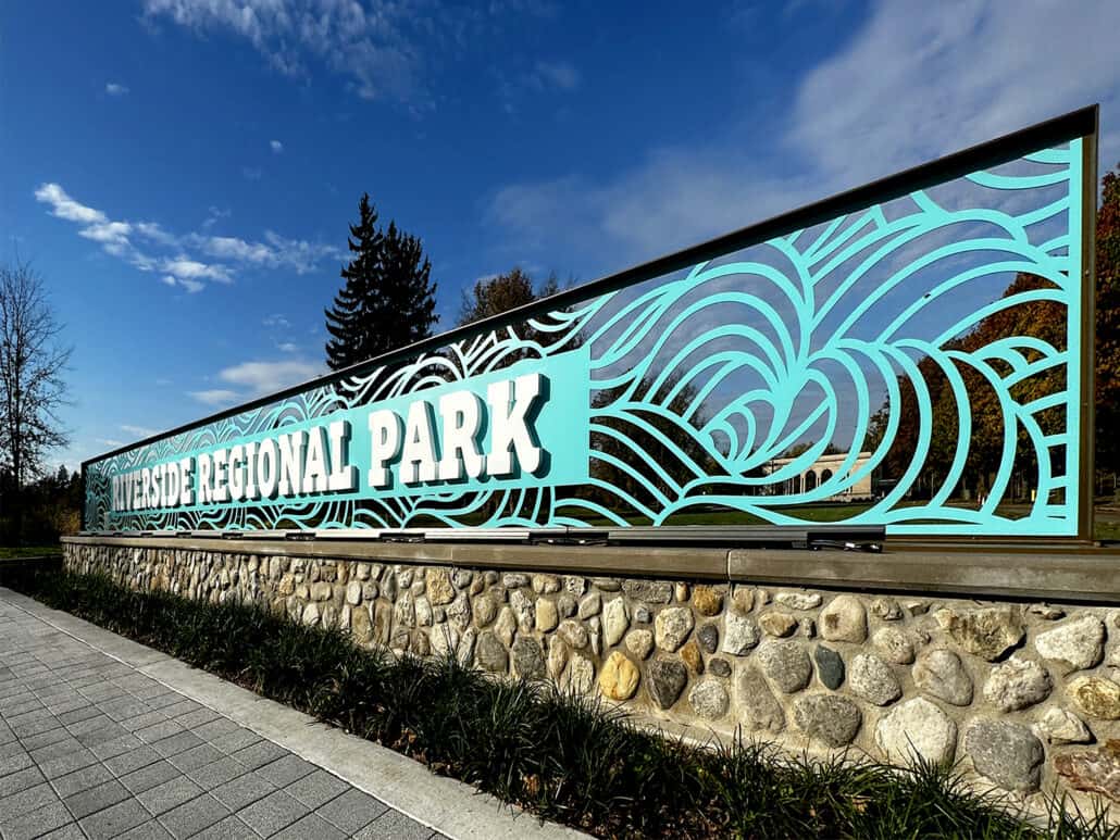 Colourful park entrance sign with intricate wave patterns for Riverside Regional Park.