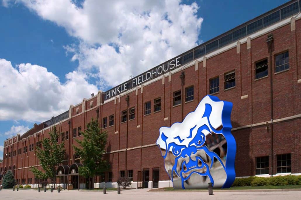Exterior view of Hinkle Fieldhouse with a large blue and white sculpture in front.